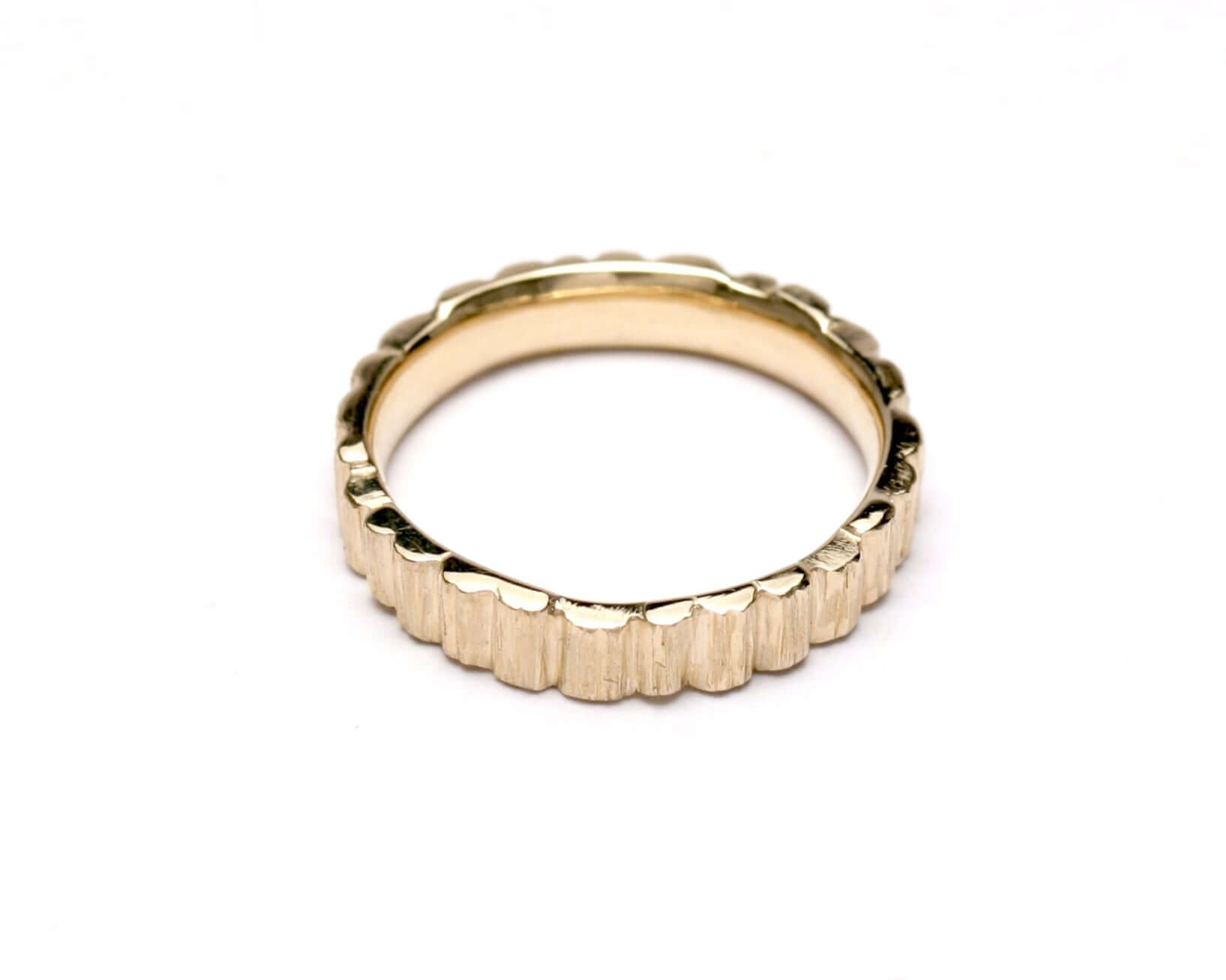 Textured gold HENGE BAND ring with rocky pillar design, showcasing its unique and elegant style.