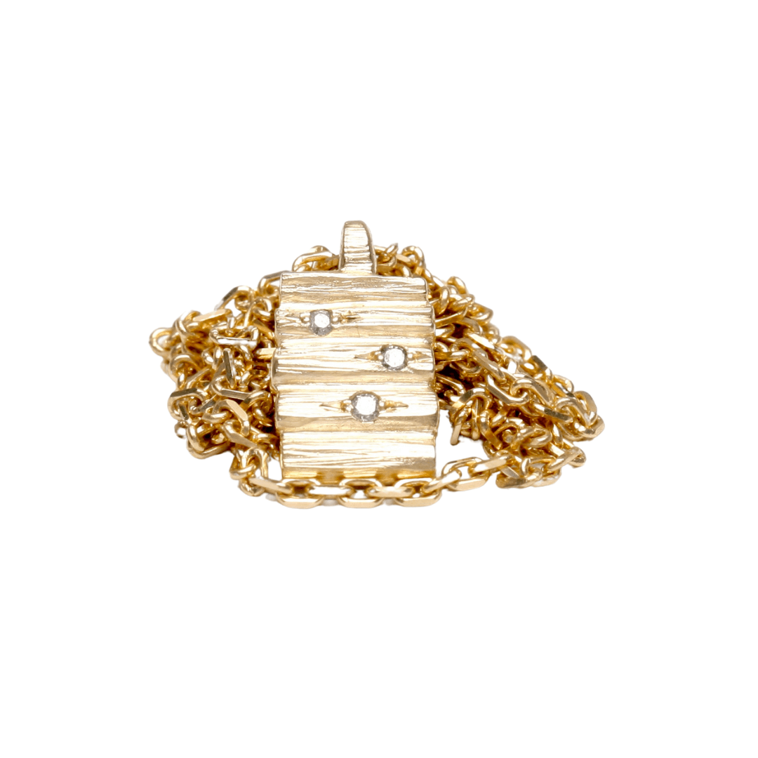 Henge pendant with salt and pepper diamonds on a yellow gold chain, showcasing an elegant and robust design.