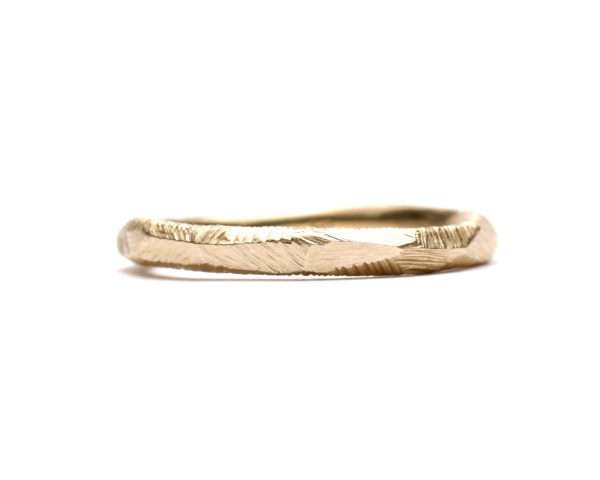 Silver ring with geometric pattern on a light gray background